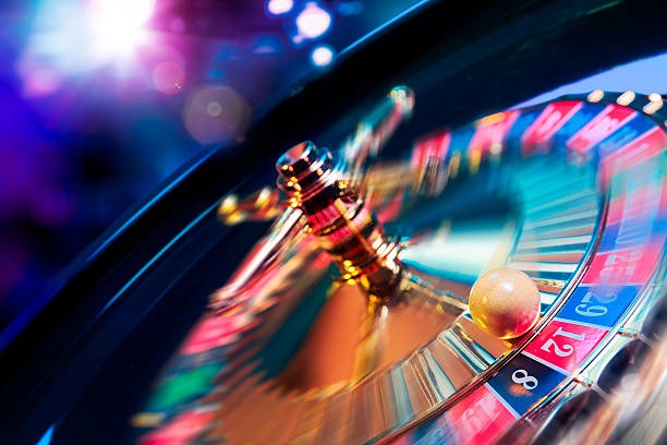 Roulette wheel spinning in The Dog House live studio with betting layout visible on mobile overlay
